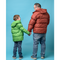 Man and child wearing bulk wholesale puffer coats / jackets holding hands against a blue background