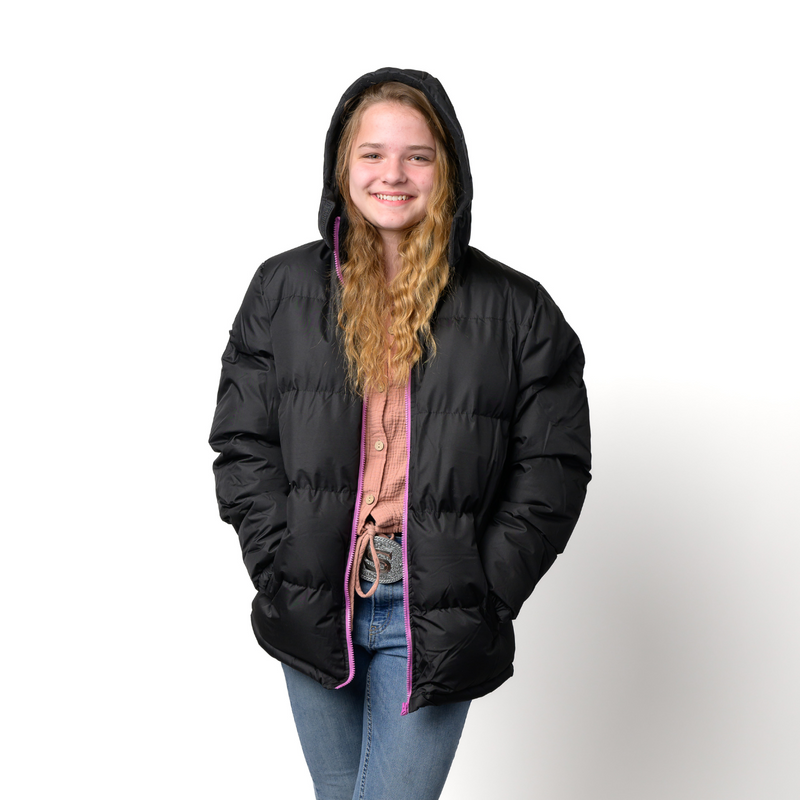 Teen wearing a wholesale bulk black puffer jacket with pink zipper on a white background